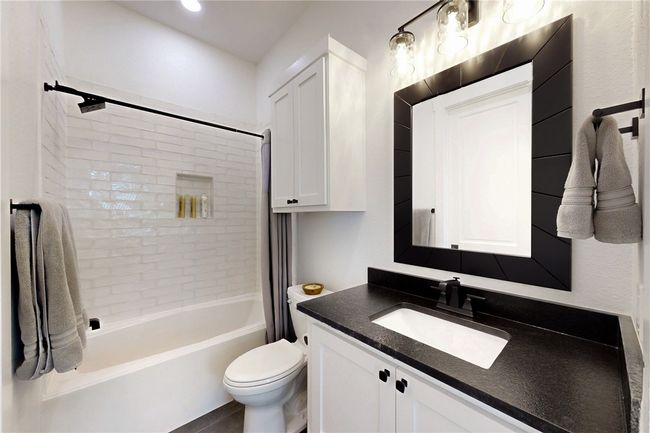 Bathroom with vanity, shower / bathtub combination, and toilet | Image 22