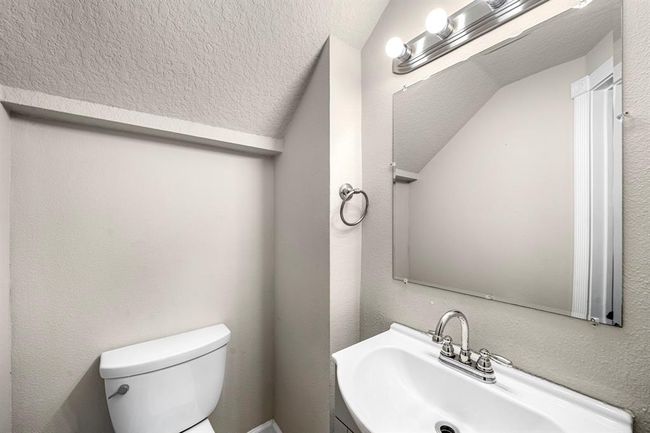 Powder room sits off the family room | Image 18