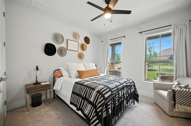 Downstairs Guest bedroom featuring 2 lg windows and a ceiling fan | Image 25