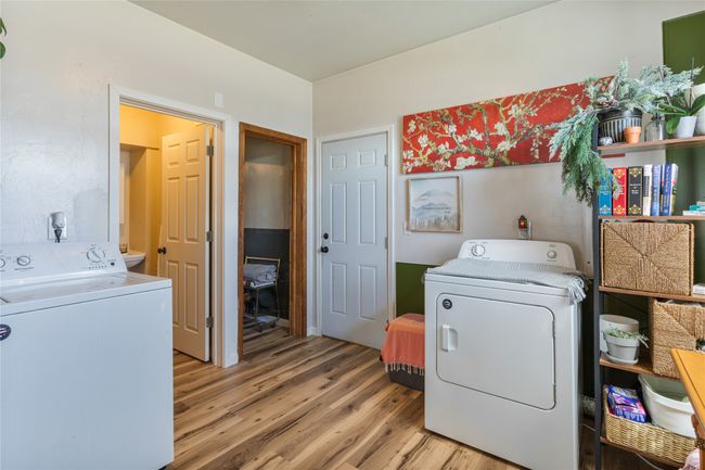 Laundry area with light wood-style flooring, laundry area, and washing machine and clothes dryer | Image 18
