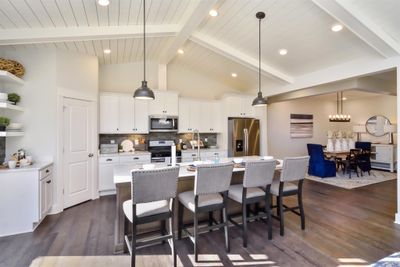 Staggered height cabinets, vaulted ceilings and granite counter tops are included in kitchen. Can it get any better?! Photo not of actual home. | Image 2