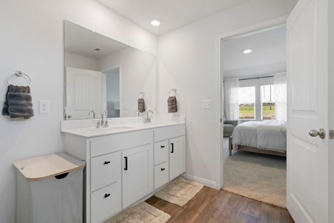 Bathroom featuring double vanity, wood finished floors, ensuite bathroom, and recessed lighting | Image 22