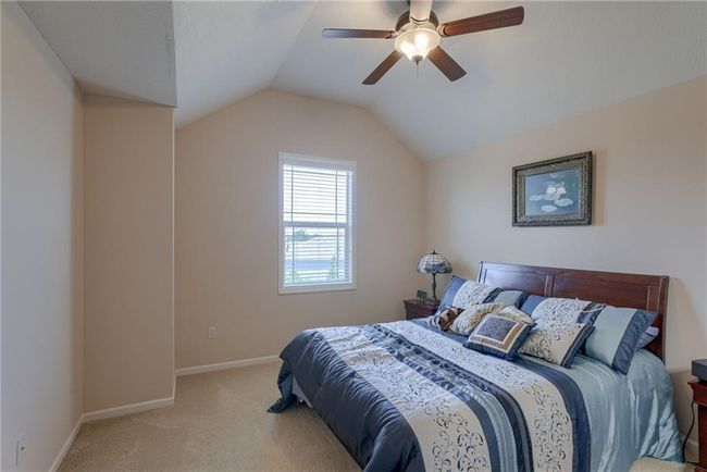 Carpeted bedroom featuring vaulted ceiling and ceiling fan | Image 20