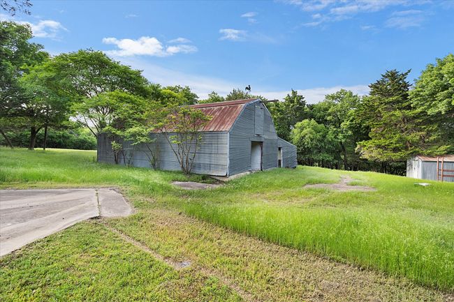 View of yard with an outdoor structure and a storage unit | Image 20