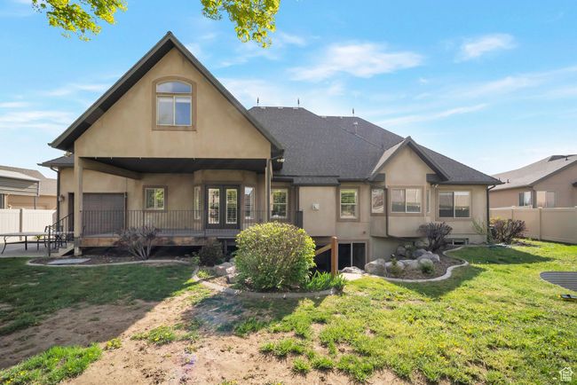 Back of house featuring fence, stucco siding, and a yard | Image 48