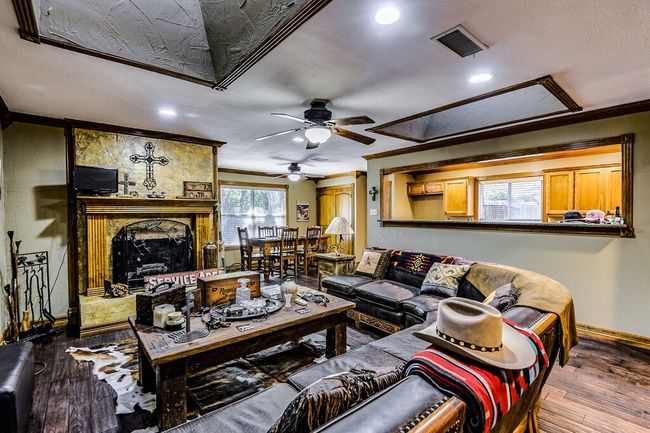 Living area with crown molding, ceiling fan, hardwood / wood-style flooring, recessed lighting, and a textured ceiling | Image 6