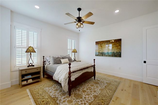 Bedroom featuring light wood-type flooring, baseboards, recessed lighting, and a ceiling fan | Image 21