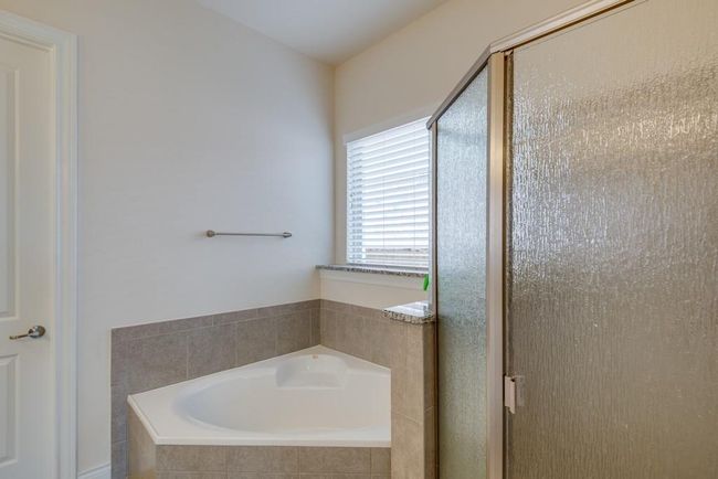 Full bathroom featuring a shower stall and a bath | Image 18