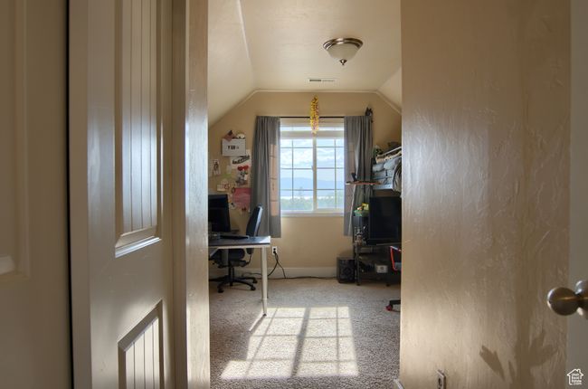 Bedroom featuring carpet floors, vaulted ceiling, visible vents, and baseboards | Image 17