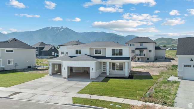 View of front of home featuring driveway, a mountain view, a shingled roof, a front yard, and a residential view | Image 33