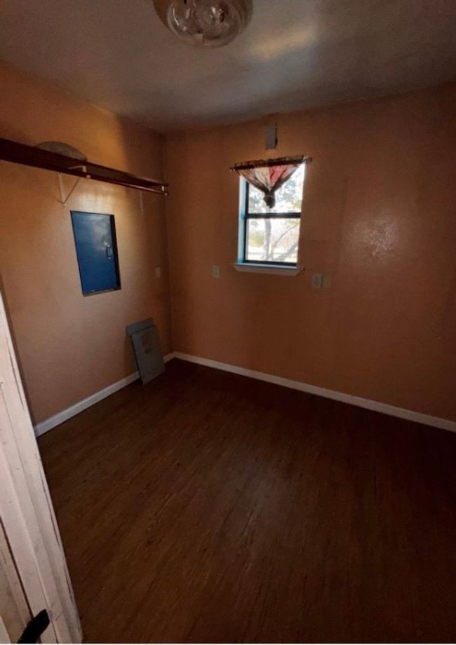 Unfurnished room with wood finished floors and baseboards | Image 7