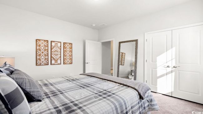 Carpeted bedroom with a closet | Image 28