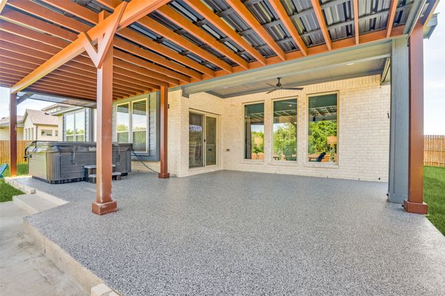View of patio featuring a hot tub and ceiling fan | Image 36