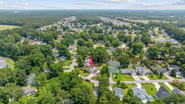 Aerial view of property and surrounding area with nearby suburban area and a heavily wooded area | Image 6