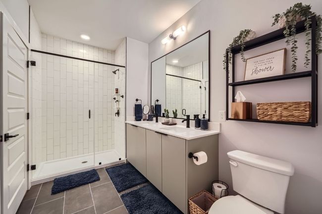 Full bathroom with tile patterned floors, double vanity, and a shower stall | Image 15