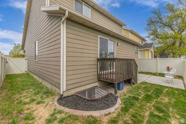 View of home's exterior featuring a lawn, a fenced backyard, a gate, and a patio | Image 23