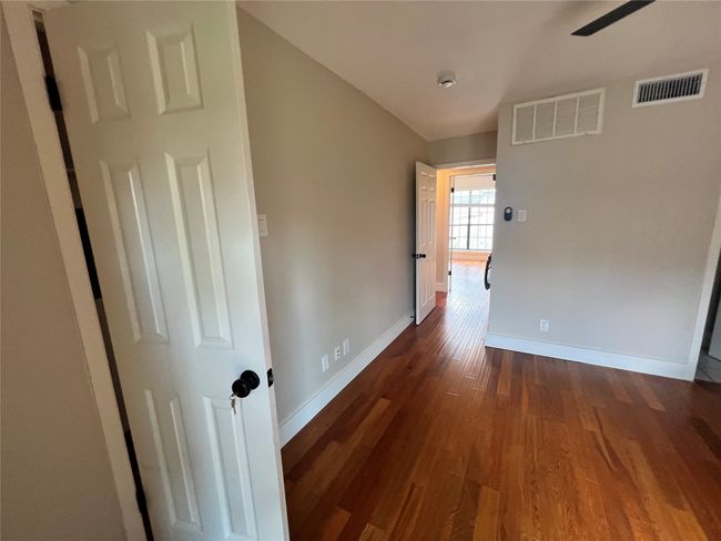 Hall featuring dark wood-style flooring and baseboards | Image 17
