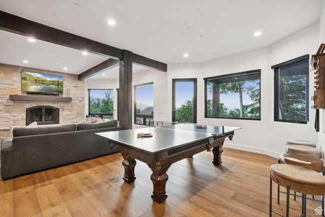 Recreation room with recessed lighting, light wood-style floors, and a fireplace | Image 49