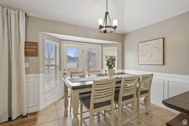 Tiled dining room with an inviting chandelier | Image 5