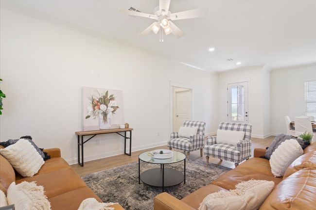 Living room with ceiling fan, light wood-style floors, recessed lighting, and crown molding | Image 8