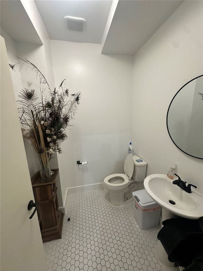 Bathroom featuring toilet, a sink, and baseboards | Image 13