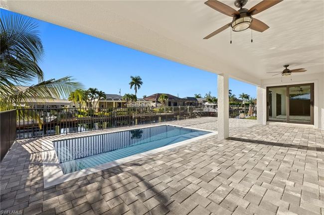 View of swimming pool with a patio and ceiling fan | Image 35