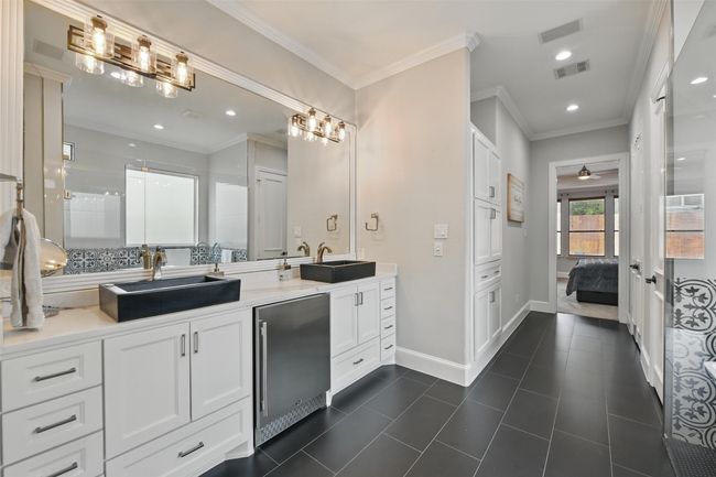 Ensuite bathroom offers ample storage space with two walk in closets. | Image 21