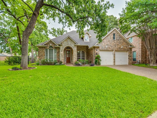 Traditional-style home features an attached front entry garage, and covered front porch. You will love the shaded front yard. | Image 30