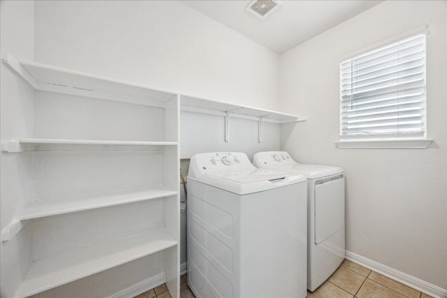 Washroom with separate washer and dryer and built-in shelves | Image 20