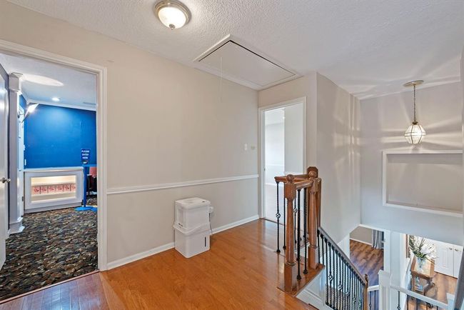Open landing at the top of the stairs could be a reading nook or study area. | Image 24
