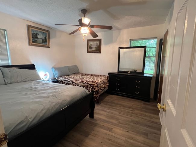Bedroom featuring a textured ceiling and a ceiling fan | Image 11