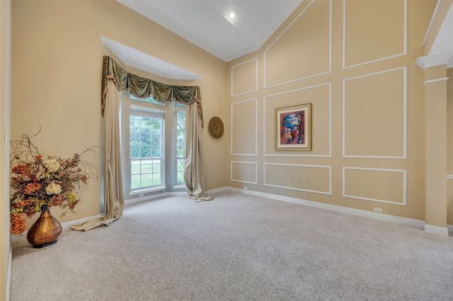 Empty room featuring crown molding, carpet, and a decorative wall | Image 6