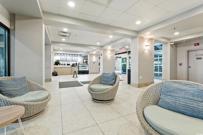 Common area with a paneled ceiling and recessed lighting | Image 22