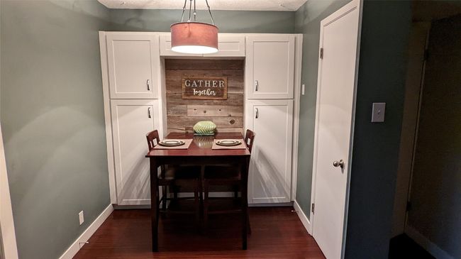Dining room with dark wood-type flooring and baseboards | Image 17
