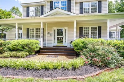 Doorway to property featuring a porch | Image 2