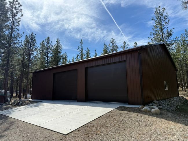View of detached garage and concrete apron | Image 49
