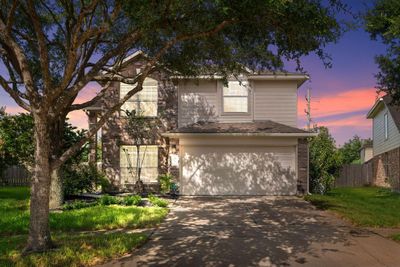 Welcome home to 6303 Applewood Forest Drive located on a quiet cul-de-sac street in Westheimer Lakes and zoned to Katy ISD! This stunning home has lovely curb appeal, beautiful landscaping, brick elevation, covered front porch, traditional style, beautiful outdoor lanterns and a double wide driveway! | Image 1