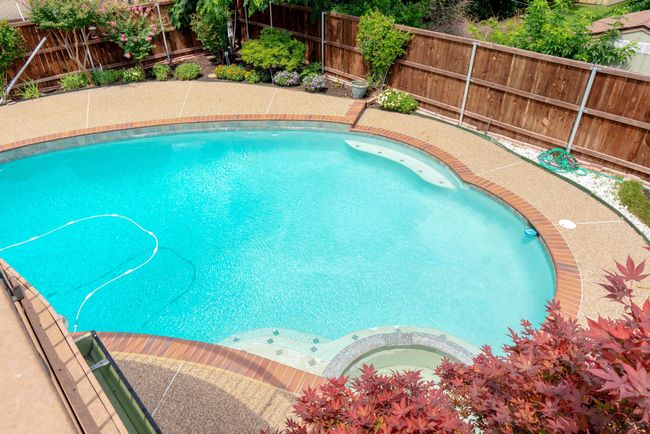 View of swimming pool featuring a fenced backyard | Image 28