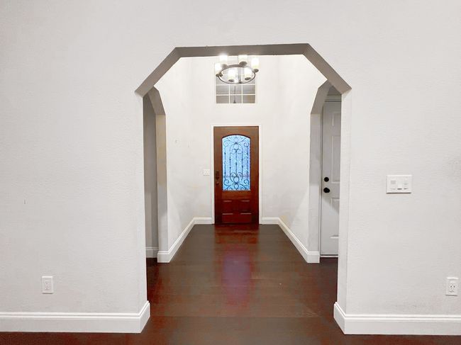 Entrance foyer featuring a notable chandelier and dark hardwood / wood-style flooring | Image 5