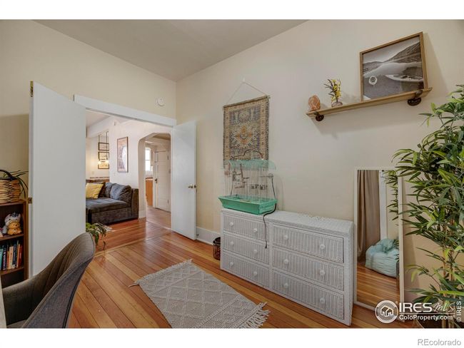 This bedroom has double doors making it a great room for an office or community space or it can simply be a bedroom. | Image 23