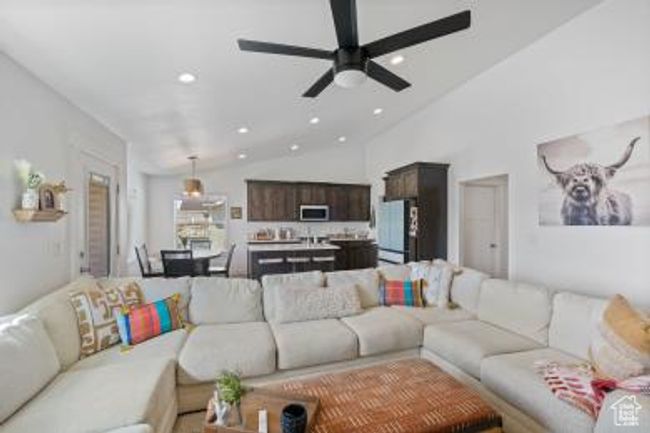 Living room with vaulted ceiling, a ceiling fan, and recessed lighting | Image 9