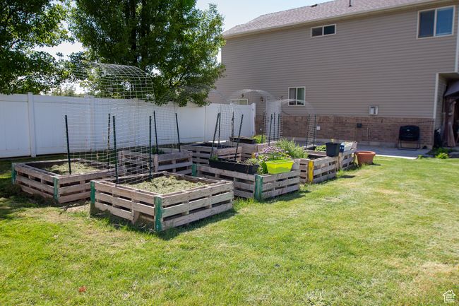 View of yard featuring raised garden beds | Image 32