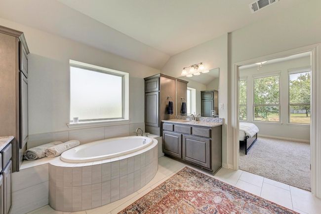 The second vanity in the owner's bath also has its own linen/storage cabinetry. | Image 26