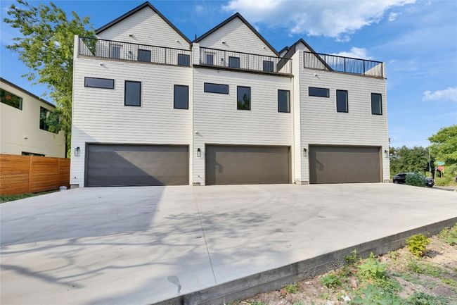 View of front facade featuring an attached garage, a balcony, and concrete driveway | Image 7