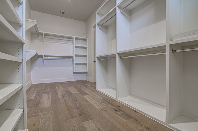 Walk in closet featuring wood finished floors | Image 13