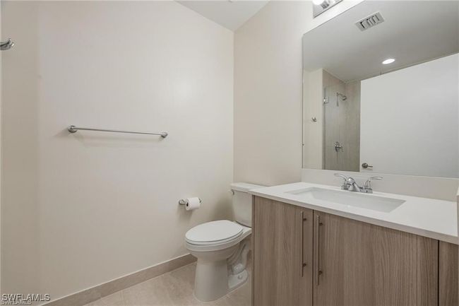 Bathroom with vanity, a shower, baseboards, toilet, and visible vents | Image 24