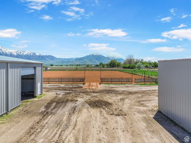 View of yard featuring an enclosed riding area, a rural view, a mountain view, and fence | Image 11