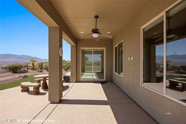 View of patio featuring a mountain view and a ceiling fan | Image 54