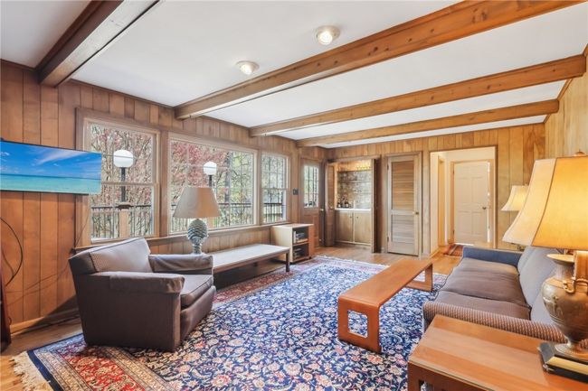 Windows frame views of park-like backyard. | Image 14