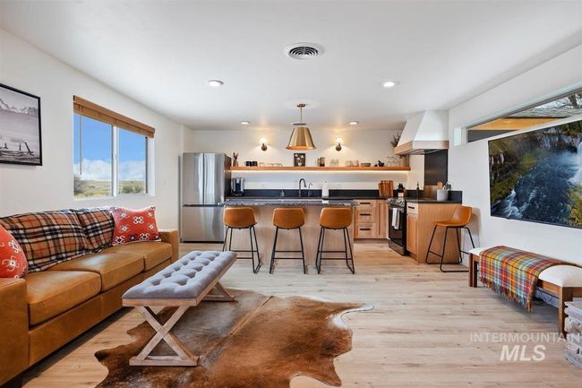 Living room with wet bar, plenty of natural light, light wood-style floors, and recessed lighting | Image 26